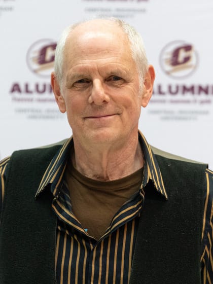 Profile shot of Mark Holen in a striped shirt.