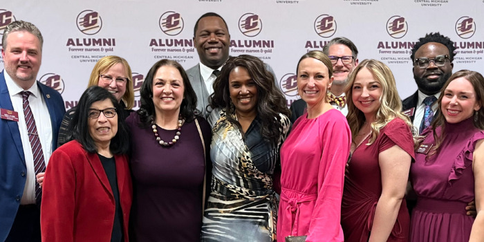 CMU Advancement team members posing as a group in front of a backdrop.