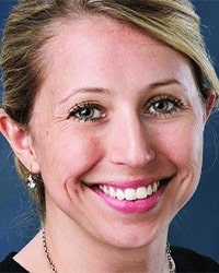 Kasee Stratton-Gadke's previous headshot for the Alumni Awards where she is wearing a black top and has blonde hair pulled back and is smiling with her teeth.