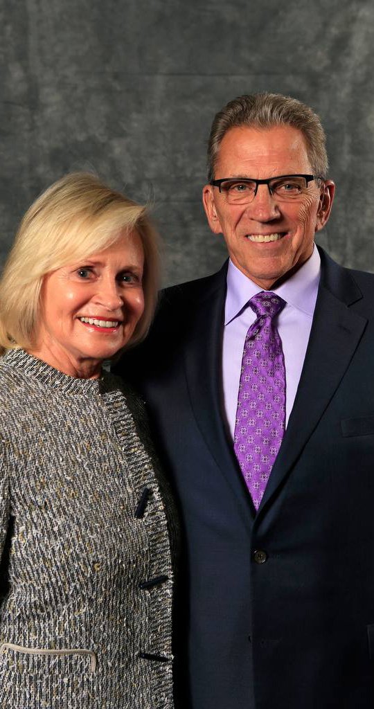 a man and woman smiling for a picture