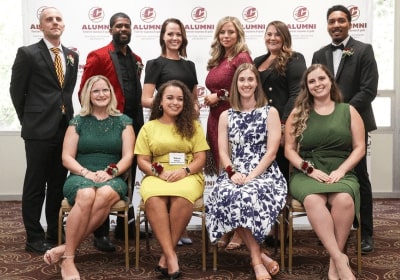 The 2023 10 within 10 recipients in front of the Central Michigan University Alumni backdrop.