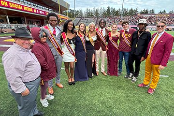 The CMU Homecoming court poses with President Davies, two trustees and the alumni board president.